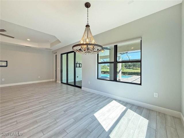 13840 Amblewind Cove Way, Fort Myers, FL 33905 - spare room with light wood-type flooring, baseboards, and a chandelier