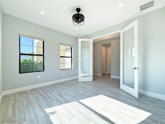 13840 Amblewind Cove Way, Fort Myers, FL 33905 - unfurnished bedroom with french doors, light wood-type flooring, baseboards, and recessed lighting