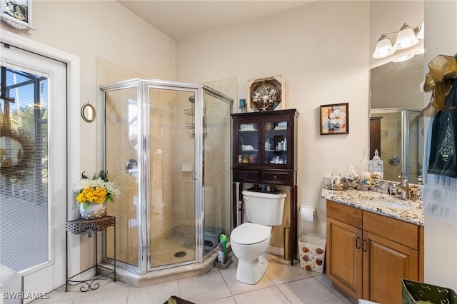 bathroom with tile patterned floors, vanity, and walk in shower