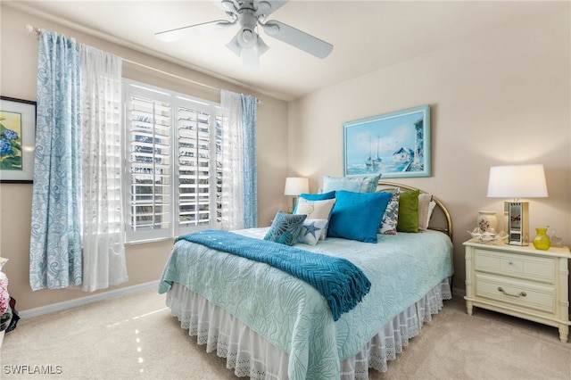 bedroom with ceiling fan and light colored carpet