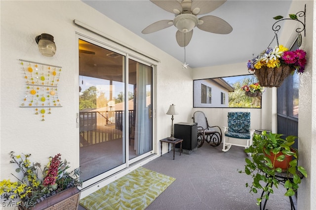 sunroom featuring ceiling fan