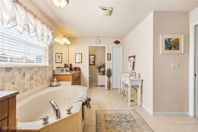 bathroom featuring tile patterned flooring, vanity, and a bathtub