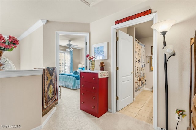 hall with light colored carpet and ornamental molding