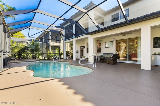 view of swimming pool featuring ceiling fan, a lanai, an outdoor hangout area, and a patio