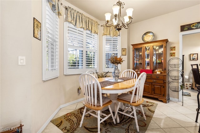 tiled dining room featuring an inviting chandelier