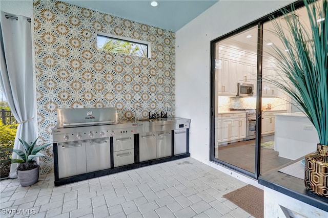 view of patio featuring a grill and an outdoor kitchen