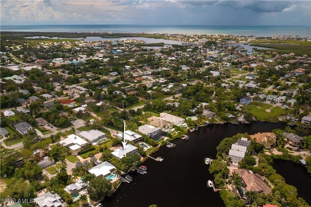 drone / aerial view with a water view and a residential view