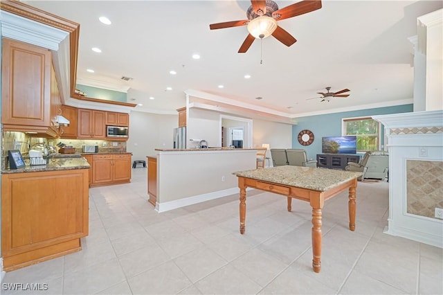 interior space featuring tasteful backsplash, a fireplace, ornamental molding, and stainless steel appliances