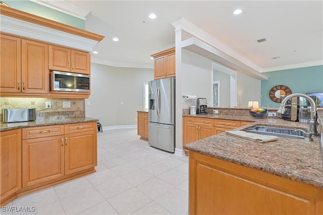 kitchen featuring tasteful backsplash, appliances with stainless steel finishes, a sink, and crown molding