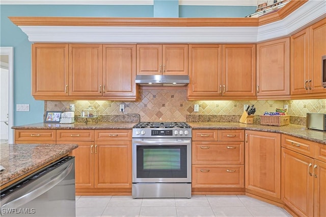 kitchen featuring light tile patterned floors, under cabinet range hood, stainless steel appliances, light stone countertops, and tasteful backsplash