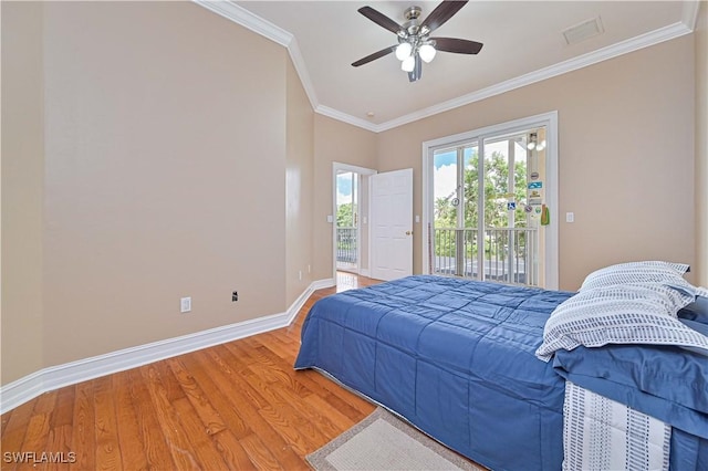 bedroom featuring wood finished floors, visible vents, baseboards, access to outside, and crown molding