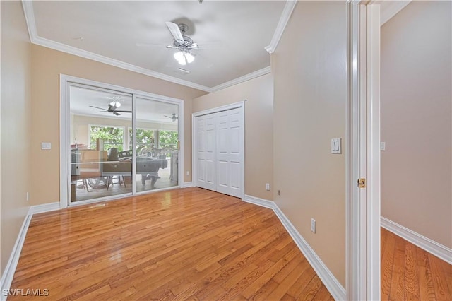 unfurnished bedroom with access to outside, ornamental molding, light wood-type flooring, and baseboards