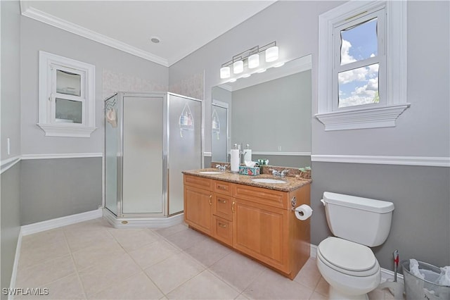 full bath featuring double vanity, a stall shower, a sink, and toilet