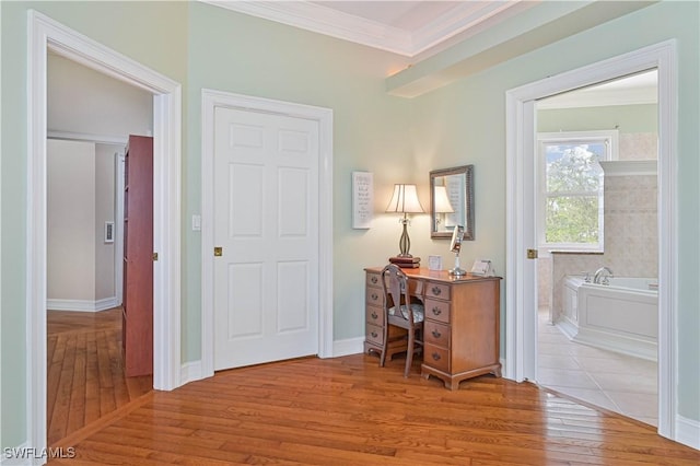 home office with crown molding, baseboards, and wood finished floors