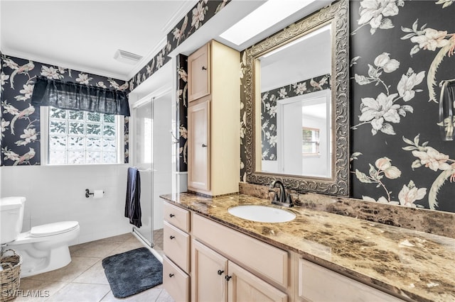 bathroom featuring toilet, tile patterned flooring, vanity, and crown molding