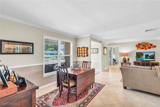 dining room featuring light tile patterned flooring and crown molding