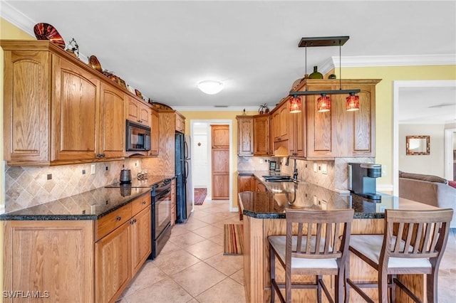 kitchen with black appliances, pendant lighting, ornamental molding, and sink