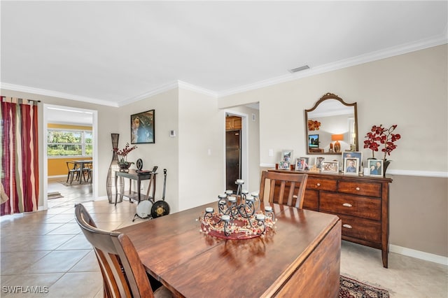 tiled dining area featuring crown molding