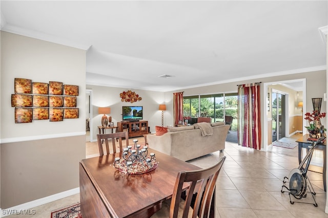 dining space featuring crown molding and light tile patterned floors