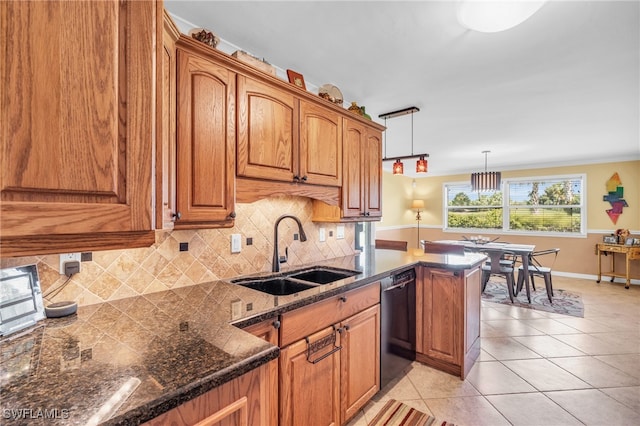 kitchen with sink, black dishwasher, light tile patterned floors, backsplash, and pendant lighting