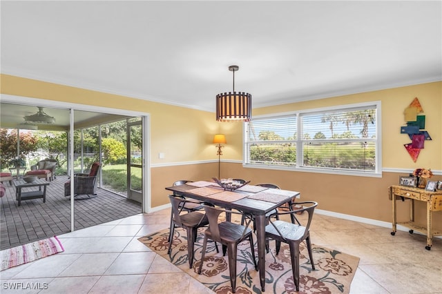 dining area featuring ornamental molding and light tile patterned floors