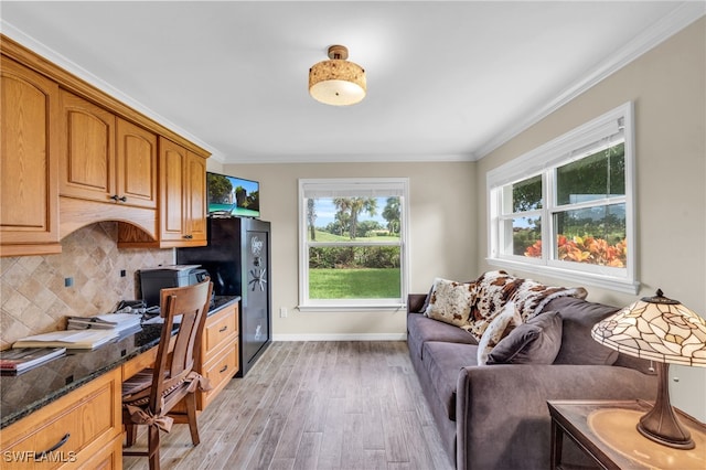 office with light hardwood / wood-style floors and crown molding