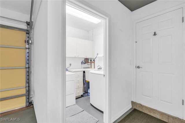 laundry room featuring cabinets and washer / dryer