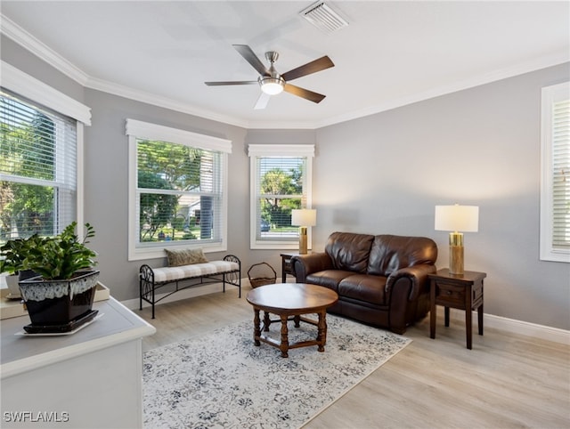 living room with crown molding, ceiling fan, and light hardwood / wood-style floors