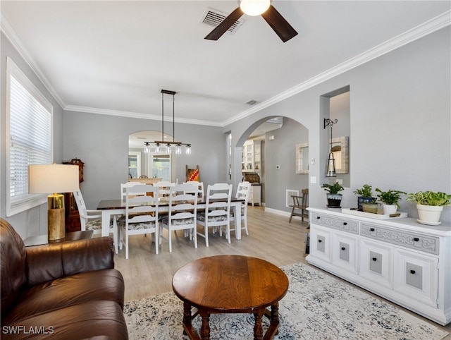 living room featuring crown molding, ceiling fan, and light hardwood / wood-style floors