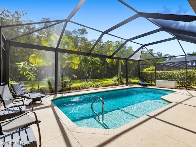 view of swimming pool featuring a lanai and a patio area