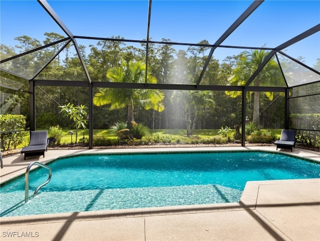 view of pool with a lanai and a patio