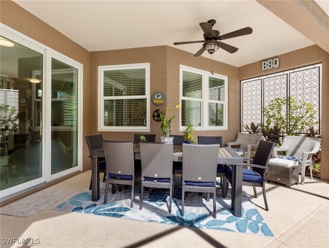 sunroom featuring ceiling fan