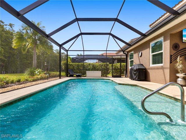 view of swimming pool with grilling area, a lanai, and a patio