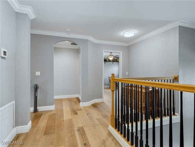 hall featuring crown molding and light hardwood / wood-style floors