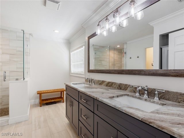 bathroom featuring an enclosed shower, ornamental molding, and vanity