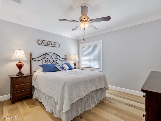 bedroom featuring ornamental molding, ceiling fan, and light hardwood / wood-style floors