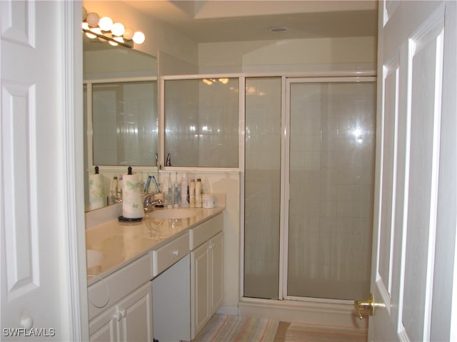 bathroom featuring an enclosed shower and vanity