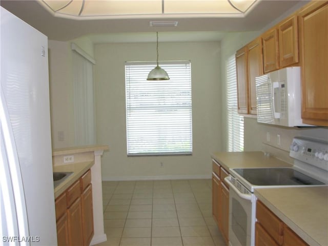 9648 Hemingway Ln Unit 4402, Fort Myers, FL 33913 - kitchen featuring white appliances, light tile patterned floors, light countertops, and healthy amount of natural light