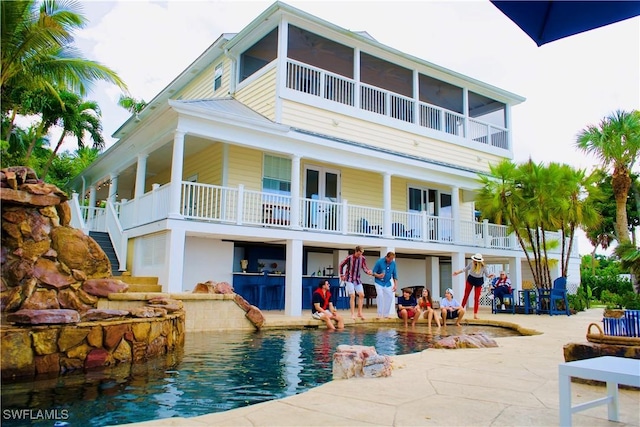 back of house featuring a patio area and a sunroom