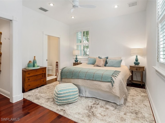 bedroom with multiple windows, hardwood / wood-style flooring, ensuite bathroom, and ceiling fan