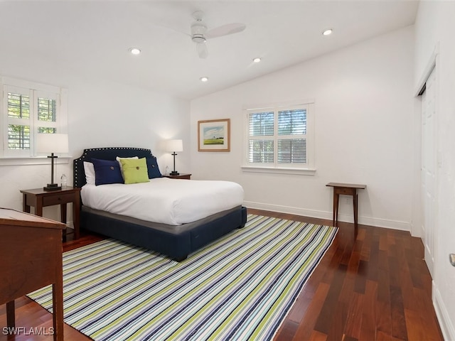 bedroom featuring lofted ceiling, dark hardwood / wood-style flooring, and ceiling fan