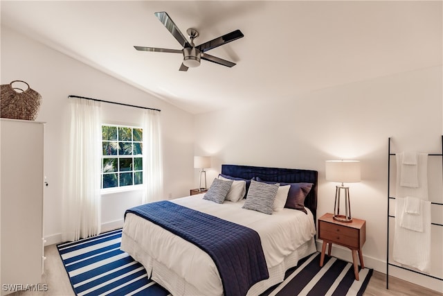 bedroom with lofted ceiling, ceiling fan, and light hardwood / wood-style flooring