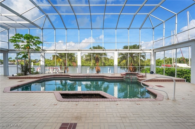 view of pool with glass enclosure, a patio, and a pool with connected hot tub