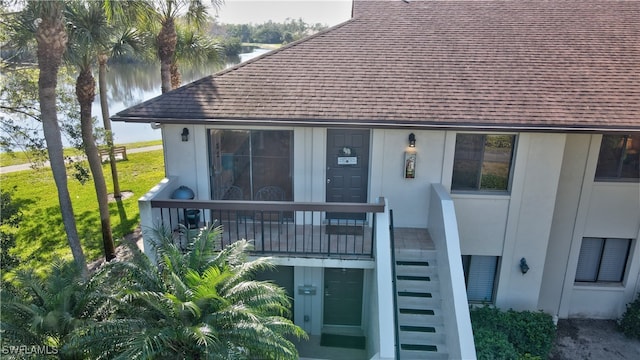 rear view of house featuring a water view