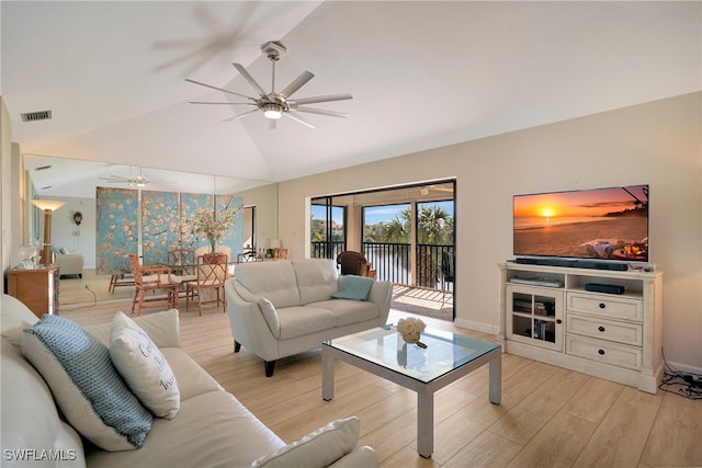 living room with ceiling fan, vaulted ceiling, and light hardwood / wood-style flooring