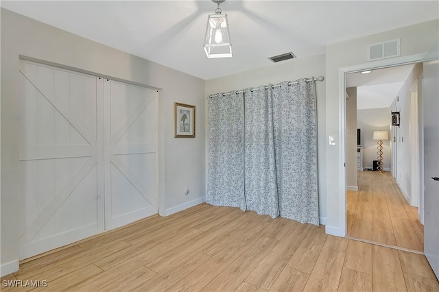 unfurnished bedroom featuring light wood-type flooring