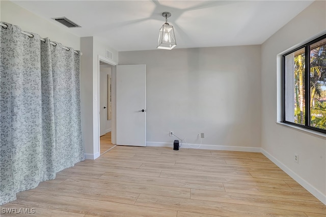 spare room featuring light hardwood / wood-style flooring