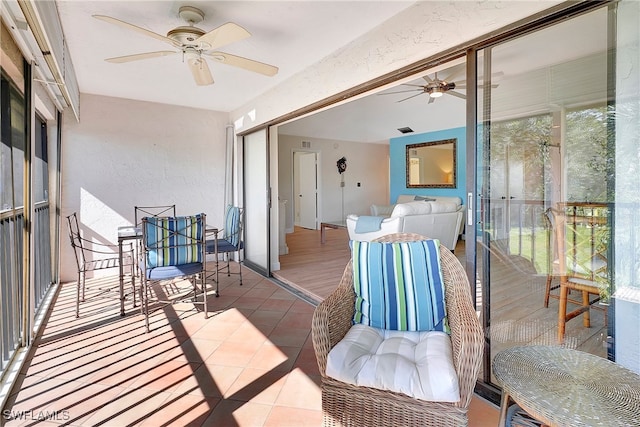 sunroom / solarium with ceiling fan