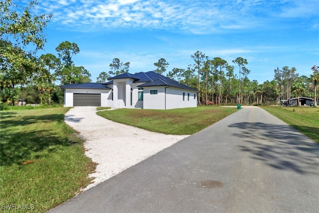 view of front facade featuring a front yard and a garage