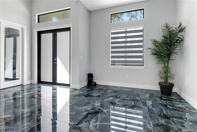 entrance foyer featuring french doors and a high ceiling